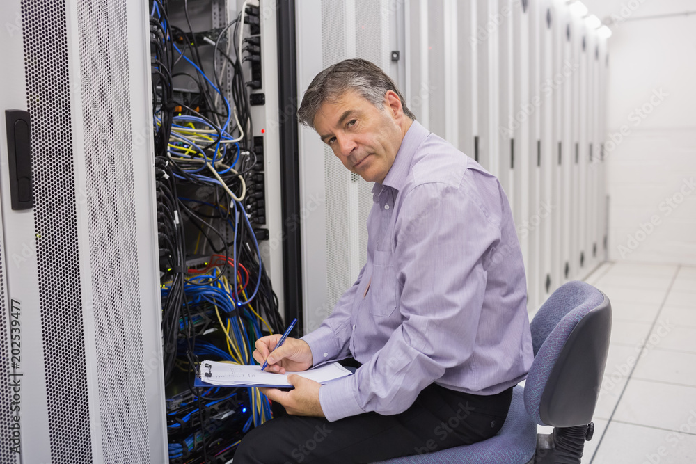 Poster Technician looking up from making notes on server