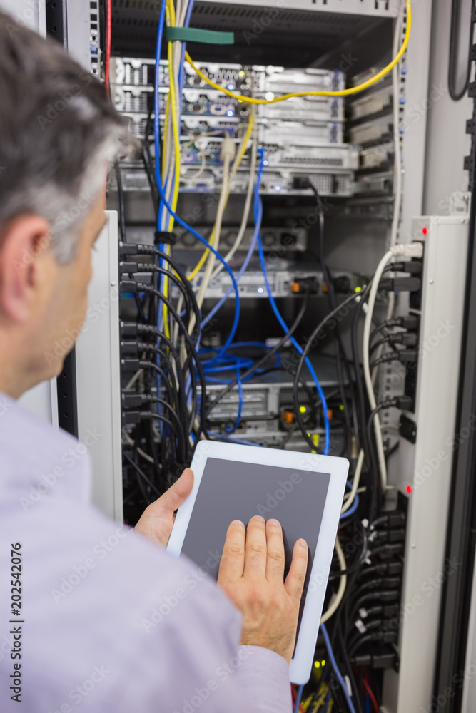 Poster technician controlling the server with a digital tablet