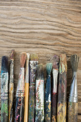 Fototapeta premium Various dirty paintbrush arranged in a row