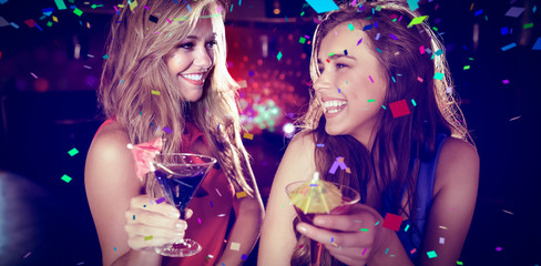 Flying colours against pretty friends drinking cocktails together - obrazy, fototapety, plakaty