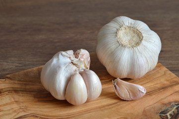 Garlic bulb and garlic cloves on wooden board