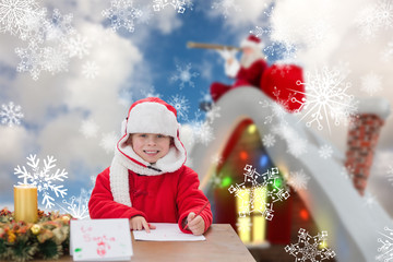 Cute boy drawing festive pictures  against blue sky with white clouds