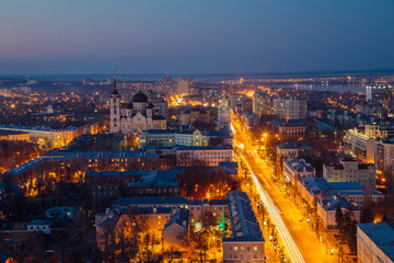 Fototapeta na wymiar Night Voronezh downtown. Aerial view from skyscraper roof height to Revolution prospect - central street of Voronezh