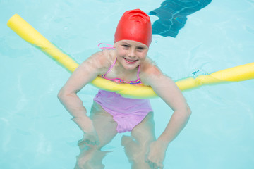 Smiling girl swimming in the pool 