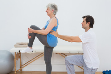 Obraz premium Male physiotherapist examining senior womans back