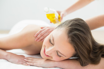 Obraz na płótnie Canvas Close up of beautiful woman enjoying oil massage