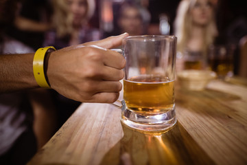 Cropped image of hand holding beer glass