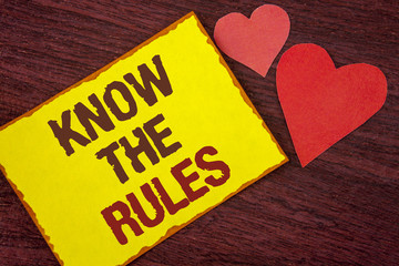 Fototapeta na wymiar Conceptual hand writing showing Know The Rules. Business photo text Understand terms and conditions get legal advice from lawyers written on Yellow Sticky note paper on wooden background Hearts.