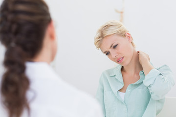 Fototapeta premium patient with neck pain visiting doctor 