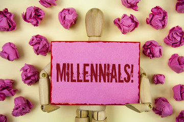 Handwriting text Millennials Motivational Call. Concept meaning Generation Y Born from 1980s to 2000s written on Sticky Note paper holding by Wooden Jointed Toy plain background Paper Ball