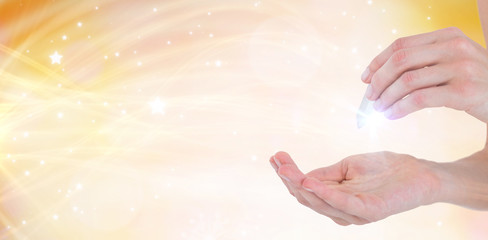 Woman holding precious gem against glowing background