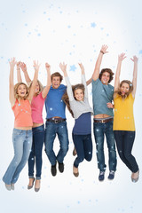 Obraz premium Celebrating friends jumping in the air against snow falling