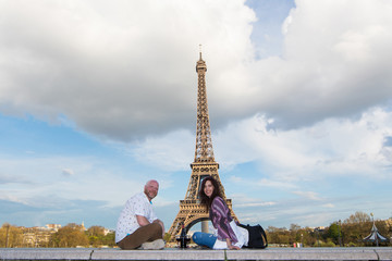 Happy couple on a romantic date at the Eiffel Tower in Paris, France