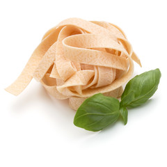 Italian pasta fettuccine nest and basil leaves  isolated on white background cutout