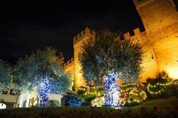 Night view of the awesome medieval Gradara castle near Pesaro city during the Christmas holidays, Marche, Italy.