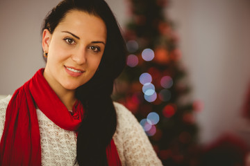 Pretty brunette relaxing on sofa at christmas