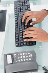 Hands using computer at medical office