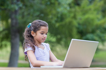 Little girl using her laptop