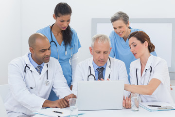 Team of doctors working on laptop
