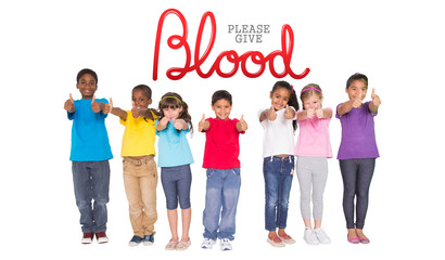 Elementary pupils smiling showing thumbs up against blood donation