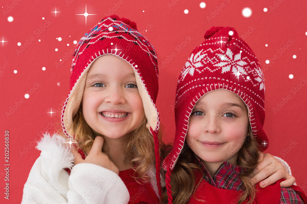 Wall mural festive little girls smiling at camera against snow