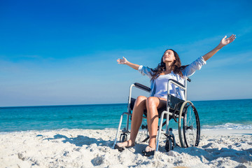 Disabled woman with arms outstretched at the beach