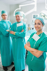 Surgical team standing up with arms crossed