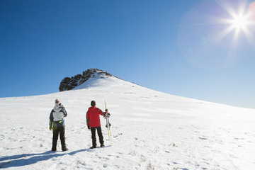 Fototapeta na wymiar Skiers on snow covered landscape on a sunny day