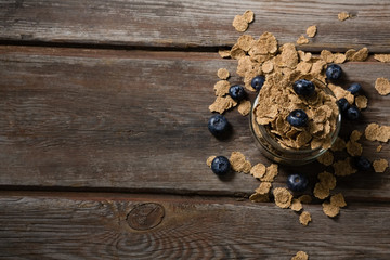 Jar filled with wheat flakes and blue berries