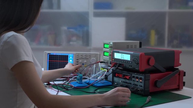 Young girl student in physical lab with hydrogen power cell