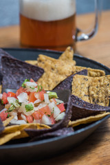 Pico de gallo with chips and a beer mug