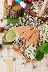 Moringa capsule for health on wood background
