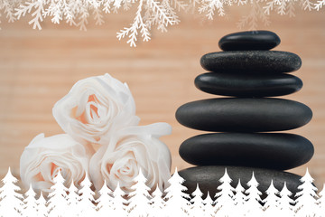 Obraz na płótnie Canvas Fir tree forest and snowflakes against close up roses and a black pebbles stack