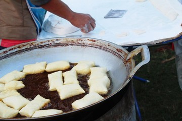 Making deep fried dough stick in market
