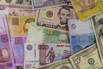Multicurrency background of the us dollars, russian rubles and ukrainian hryvnias