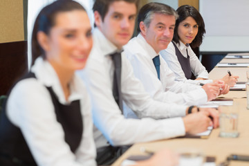 Smiling business people in a row