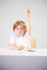 Cute pupil raising hand against grey vignette