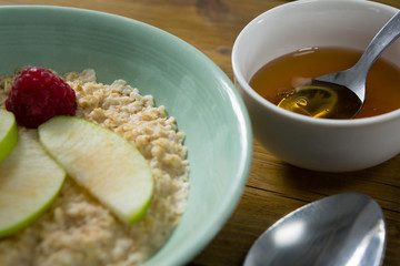 Fruit cereal and honey on wooden table