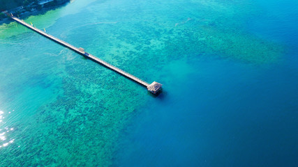 Wooden jetty with turquoise water at Labuan Bajo