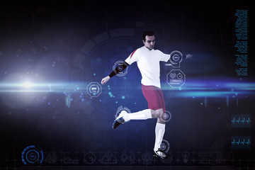 Fototapeta na wymiar Football player in white kicking against blue dots on black background