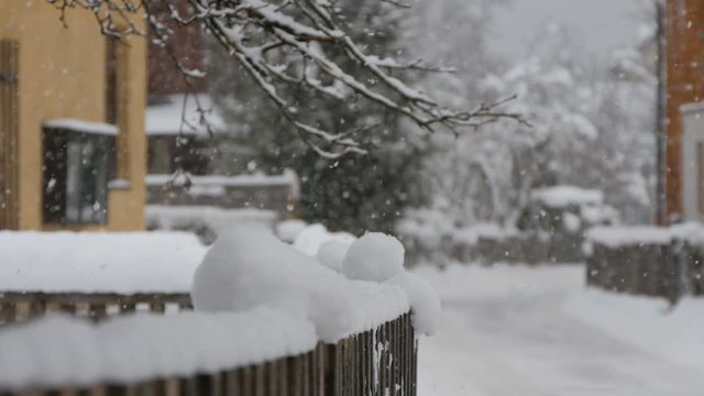 Wooden fence covered with snow 