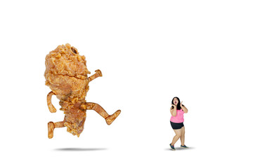 Fat woman chased by a fried chicken on studio