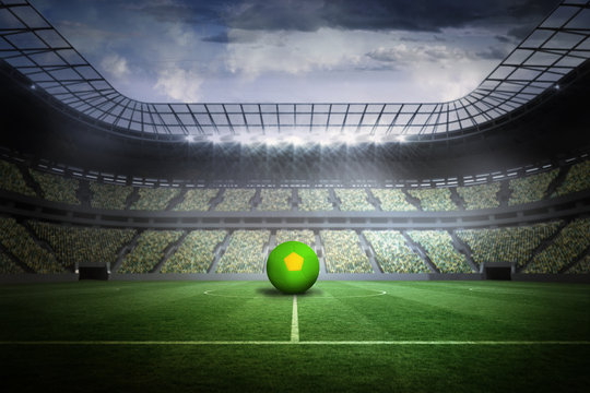 Bright green and yellow football in a large football stadium with fans in yellow