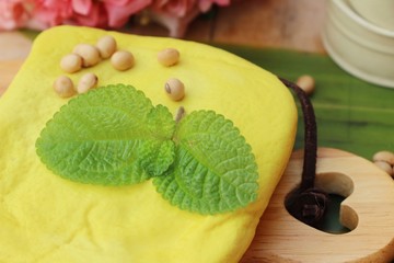 Tofu and soybean seed on wood background