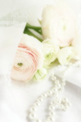 Obraz na płótnie Canvas Blur effect, soft focus flowers background with bouquet of pale pink ranunculus on white linen background .Beautiful Holiday background.copy space.