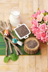 Fototapeta na wymiar Organic chia in seeds on wood background