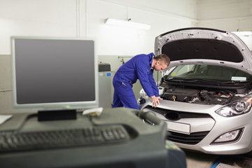 Mechanic examining a car engine