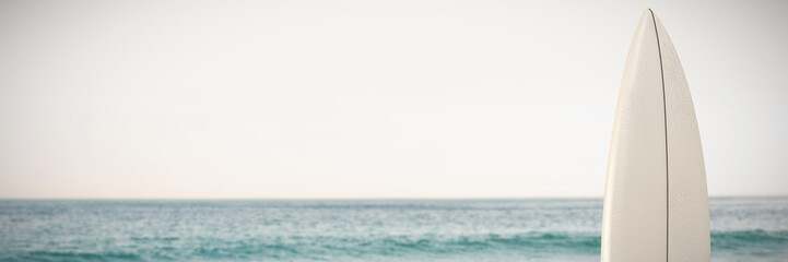 White surfboard against scenic view of ocean