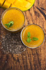 Fresh mango smoothie in glass with chia seeds