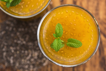 Fresh mango smoothie in glass with chia seeds